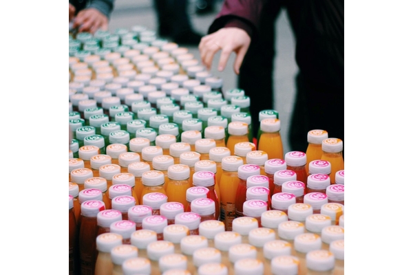 Image A table filled with various bottles of juice, showcasing a colorful assortment of flavors from Innocent.